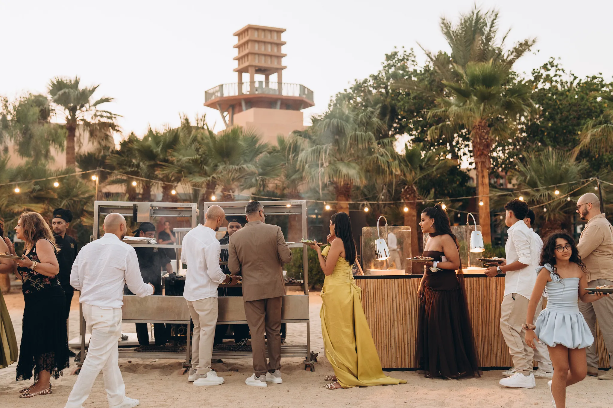Guests dining at an El Gouna wedding under palm trees
