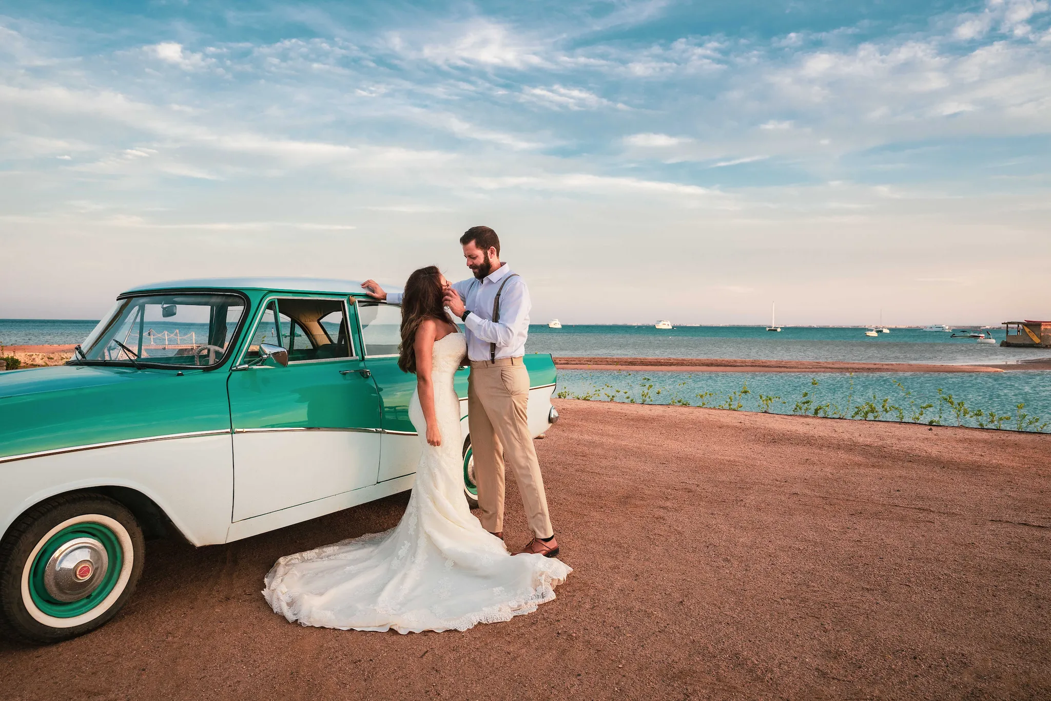 Bride and groom on an El Gouna lagoon bridge at sunset