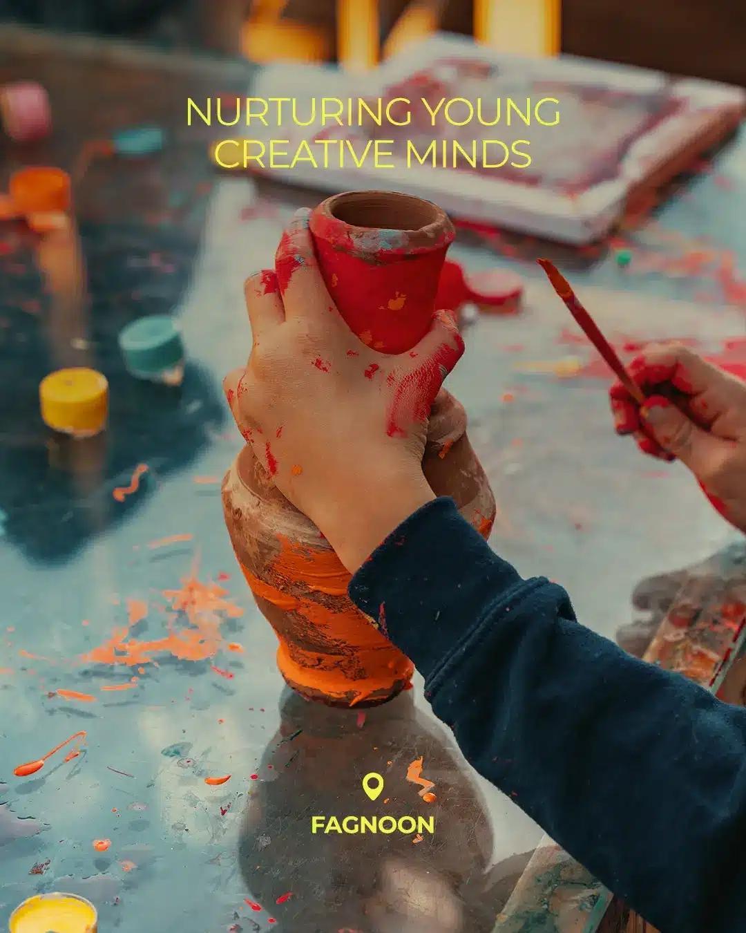 Child painting pottery during a creative arts activity at Fagnoon in El Gouna.