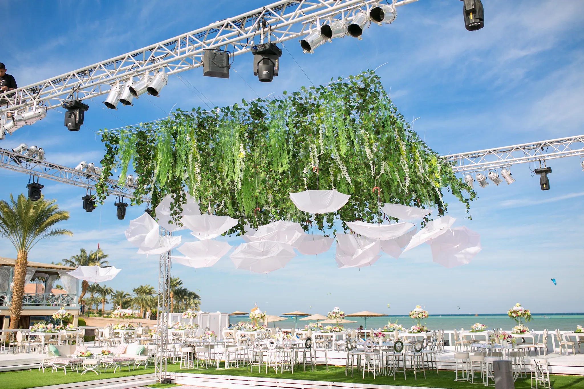 El Gouna beach wedding with hanging umbrellas and greenery